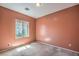 Bedroom with a carpet and window showcasing outdoor views at 5960 Wheat Penny Ave, Las Vegas, NV 89122