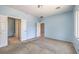 Spacious bedroom with carpet, multiple doors, and blue walls at 5960 Wheat Penny Ave, Las Vegas, NV 89122