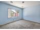 Bedroom with carpet, and a large window overlooking the neighborhood at 5960 Wheat Penny Ave, Las Vegas, NV 89122