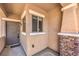 Covered front porch showcasing a secure entrance and beautiful stone accents at 5960 Wheat Penny Ave, Las Vegas, NV 89122