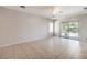 Spacious and bright living area with neutral paint, tile floors, and sliding glass doors at 5960 Wheat Penny Ave, Las Vegas, NV 89122