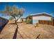 Spacious backyard featuring a tree and partial views of the house and shed at 6121 Iris Cir, Las Vegas, NV 89107