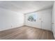 A sunny bedroom offers ample lighting, hardwood floors, and a door to the hallway at 6121 Iris Cir, Las Vegas, NV 89107