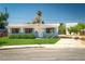 Charming single-story home featuring a well-manicured lawn and freshly painted exterior at 6121 Iris Cir, Las Vegas, NV 89107