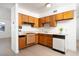 Efficient kitchen featuring wood cabinets, updated appliances, and an outside access door at 6121 Iris Cir, Las Vegas, NV 89107