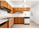 Efficient kitchen featuring wood cabinets, updated appliances, and a functional layout at 6121 Iris Cir, Las Vegas, NV 89107