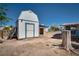 View of the shed in the backyard with a tree stump in the foreground at 6121 Iris Cir, Las Vegas, NV 89107