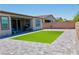 Backyard with paver patio, enclosed with a brick wall and a patch of artificial grass at 6250 Lamont Hills Ave, Las Vegas, NV 89139