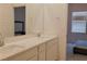 Bathroom featuring double sinks, and a large mirror reflecting the bright, neutral-toned space at 6250 Lamont Hills Ave, Las Vegas, NV 89139