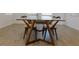 Modern dining table with a glass top and unique wooden chairs at 6250 Lamont Hills Ave, Las Vegas, NV 89139