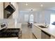 Modern kitchen with a view of the dining area and stainless steel appliances at 6250 Lamont Hills Ave, Las Vegas, NV 89139