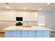 Well-lit kitchen featuring white cabinets, marble countertops, and stainless steel appliances at 6250 Lamont Hills Ave, Las Vegas, NV 89139