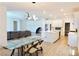 Bright open-concept living space with modern lighting, dining area, and well-appointed kitchen at 6250 Lamont Hills Ave, Las Vegas, NV 89139