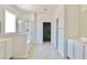 Bright and airy main bathroom with a glass-enclosed shower and double vanity at 6250 Lamont Hills Ave, Las Vegas, NV 89139