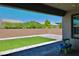 Outdoor patio with neutral pavers and faux grass creating a low maintenance outdoor space at 6250 Lamont Hills Ave, Las Vegas, NV 89139
