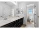 Bright bathroom featuring a double sink vanity, a large mirror, and access to an additional bathroom at 6354 Point Isabel Way, Las Vegas, NV 89122