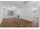 Spacious carpeted bedroom featuring a window with blinds for natural light and an open doorway to an adjacent room at 6354 Point Isabel Way, Las Vegas, NV 89122