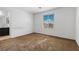 Comfortable carpeted bedroom with a window overlooking the neighborhood and an en-suite bathroom at 6354 Point Isabel Way, Las Vegas, NV 89122