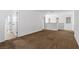 Expansive carpeted bedroom with a window providing natural light and connecting doors to other rooms at 6354 Point Isabel Way, Las Vegas, NV 89122