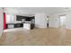 Open concept kitchen with dark cabinets, island, and tile flooring at 6354 Point Isabel Way, Las Vegas, NV 89122