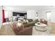 Open-concept living room with elegant decor, modern furnishings, and seamless flow to the kitchen at 6354 Point Isabel Way, Las Vegas, NV 89122