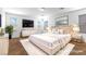 A staged main bedroom featuring a luxurious bed and modern decor at 6354 Point Isabel Way, Las Vegas, NV 89122