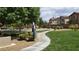 Community park featuring a walking path, mature trees, and open green space for recreation at 6354 Point Isabel Way, Las Vegas, NV 89122