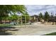 Community playground featuring swings, covered picnic benches, and ample space for outdoor activities at 6354 Point Isabel Way, Las Vegas, NV 89122