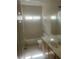 Bright bathroom features a tiled shower-over-tub, a large mirror, and a vanity with ample storage at 7228 Chic Ave, Las Vegas, NV 89129