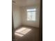 This cozy bedroom features neutral carpeting and a bright window, offering a peaceful retreat at 7228 Chic Ave, Las Vegas, NV 89129