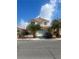 Two-story home with desert landscaping, garage, and a red tile roof on a sunny day at 7228 Chic Ave, Las Vegas, NV 89129