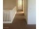 Upstairs hallway with carpet flooring, leading to rooms with neutral wall colors at 7228 Chic Ave, Las Vegas, NV 89129