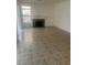 Living room with tile flooring and a fireplace, illuminated by natural light at 7228 Chic Ave, Las Vegas, NV 89129