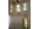 An open upper level with views to the first floor, enhanced by bright natural light and neutral finishes at 7228 Chic Ave, Las Vegas, NV 89129