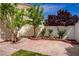 Charming backyard featuring a brick-paved area, mature trees, and a well-maintained block wall, ideal for outdoor relaxation at 7924 Horn Tail Ct, Las Vegas, NV 89131