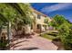 Spacious backyard showcasing brick paving, mature trees, a covered patio, and ample space for outdoor entertaining at 7924 Horn Tail Ct, Las Vegas, NV 89131