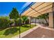 Backyard patio with pergola, brick pavers, mature landscaping and blue skies at 7924 Horn Tail Ct, Las Vegas, NV 89131