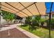 Backyard patio with pergola, brick pavers, and mature landscaping at 7924 Horn Tail Ct, Las Vegas, NV 89131