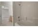 Bathroom with white tiled shower over tub and tile floor at 7924 Horn Tail Ct, Las Vegas, NV 89131