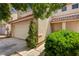 Charming home with an attached two-car garage, tiled roof, and green landscaping at 7924 Horn Tail Ct, Las Vegas, NV 89131