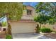 Lovely two-story home with a two-car garage, tile roof, and mature trees providing shade and curb appeal at 7924 Horn Tail Ct, Las Vegas, NV 89131