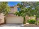 Charming two-story home featuring a two-car garage, lush landscaping, and a tiled roof in a desirable neighborhood at 7924 Horn Tail Ct, Las Vegas, NV 89131