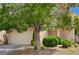 Inviting home featuring a well-maintained lawn, mature trees, and an attached two-car garage at 7924 Horn Tail Ct, Las Vegas, NV 89131