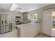 Modern kitchen with stainless steel appliances, breakfast bar, and bright lighting at 7924 Horn Tail Ct, Las Vegas, NV 89131