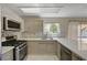Modern kitchen featuring stainless appliances and stone backsplash at 7924 Horn Tail Ct, Las Vegas, NV 89131