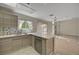 Modern kitchen features stainless appliances, stone backsplash and open floor plan at 7924 Horn Tail Ct, Las Vegas, NV 89131