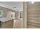 Modern kitchen featuring stainless dishwasher, stone backsplash and walk-in pantry at 7924 Horn Tail Ct, Las Vegas, NV 89131