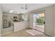 Modern kitchen featuring stainless steel appliances, stylish backsplash, and open access to the dining area and backyard at 7924 Horn Tail Ct, Las Vegas, NV 89131