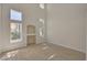 Bright living room featuring soaring ceilings, large windows, and modern flooring at 7924 Horn Tail Ct, Las Vegas, NV 89131