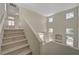 Grand staircase with natural light flooding through large windows at 7924 Horn Tail Ct, Las Vegas, NV 89131
